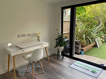 inside of a garden room with patio doors open