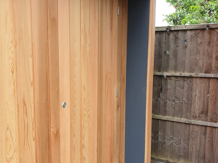 cedar clad bike store in twickenham with hidden door.jpg
