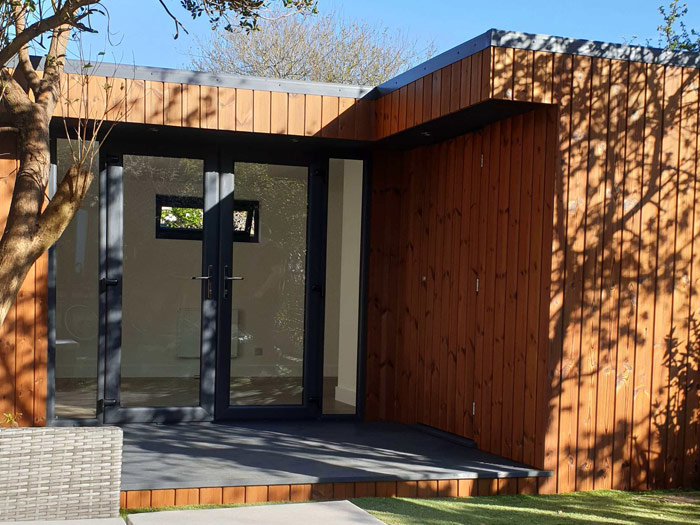 L-shaped garden room and store with deck in Enfield
